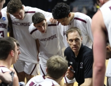 Basketball coach speaking with players